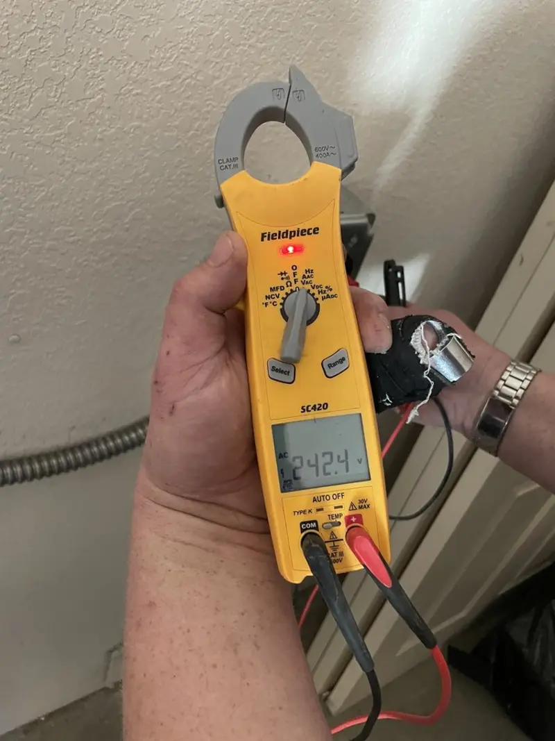 Voltage testing with clamp meter during Ceiling Fan Installation in Booneville